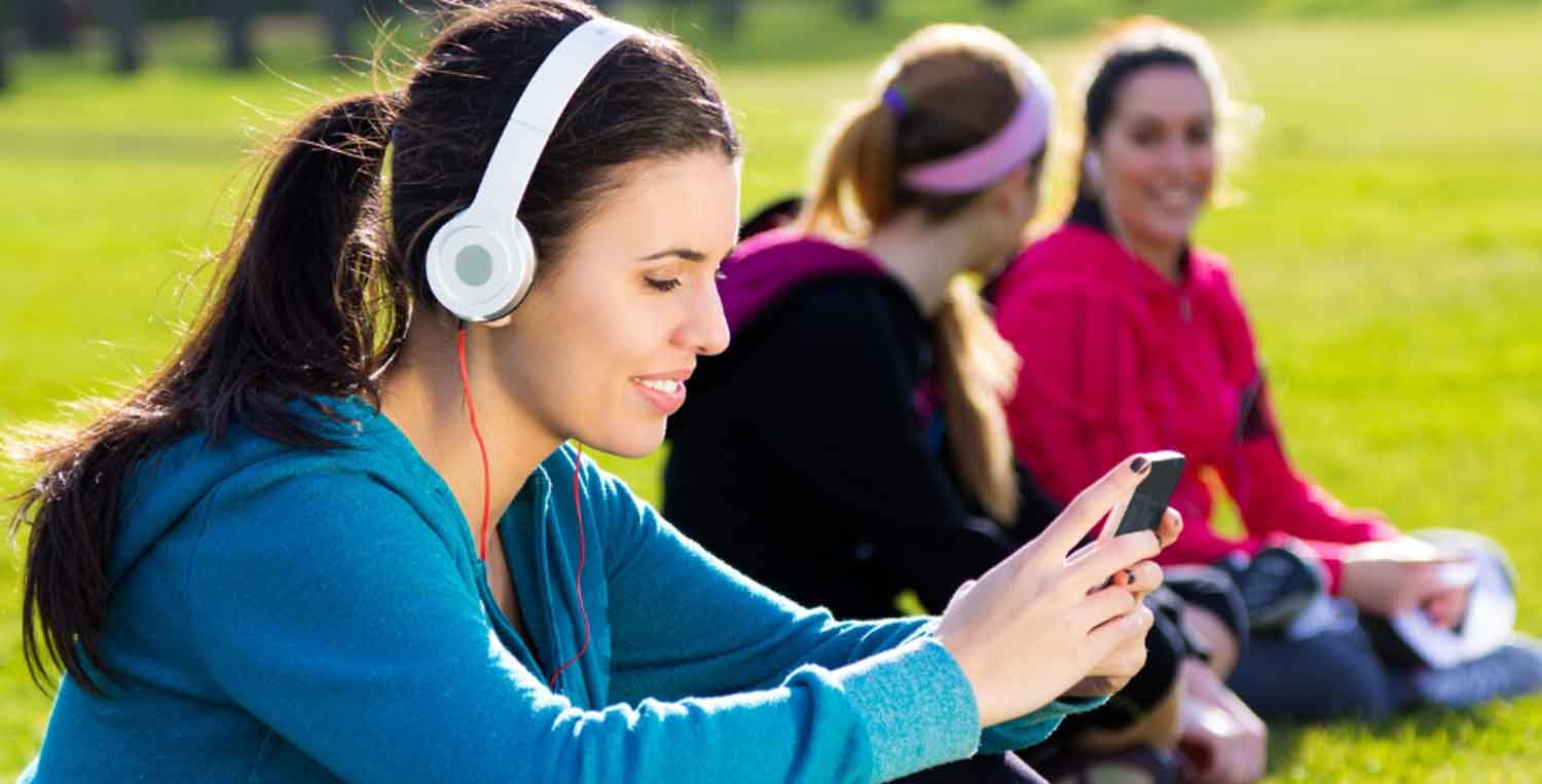 Happy woman relaxing and listening to Christian music for stress with headphones in a peaceful moment